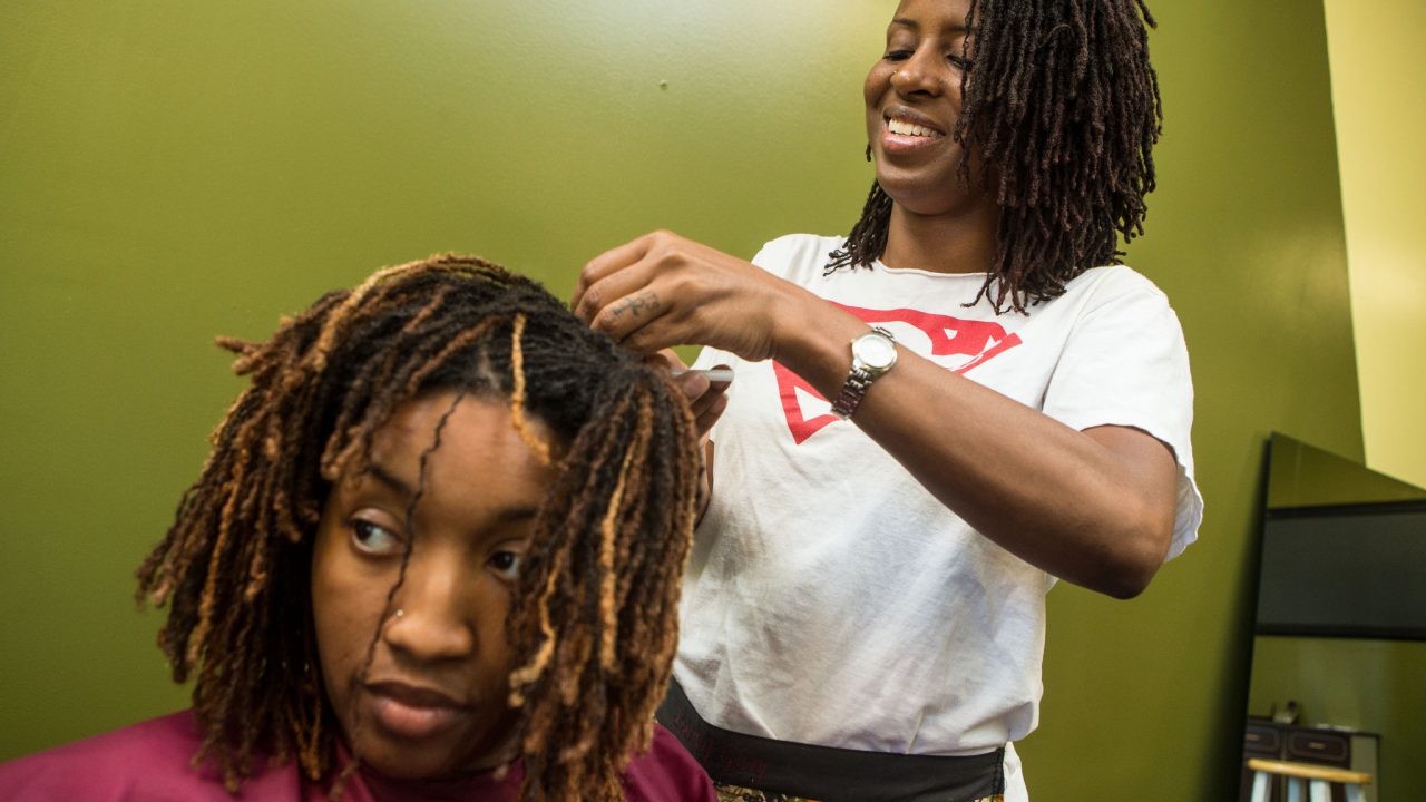 General caption info---Tameka Stigers (White Shirt), LaQuinn Laws (customer getting hair braided) , Ivy Perry (Black Shirt, sister of Tameka Stigers) Photographed in St. Louis, Missouri on Friday, June 13, 2014.