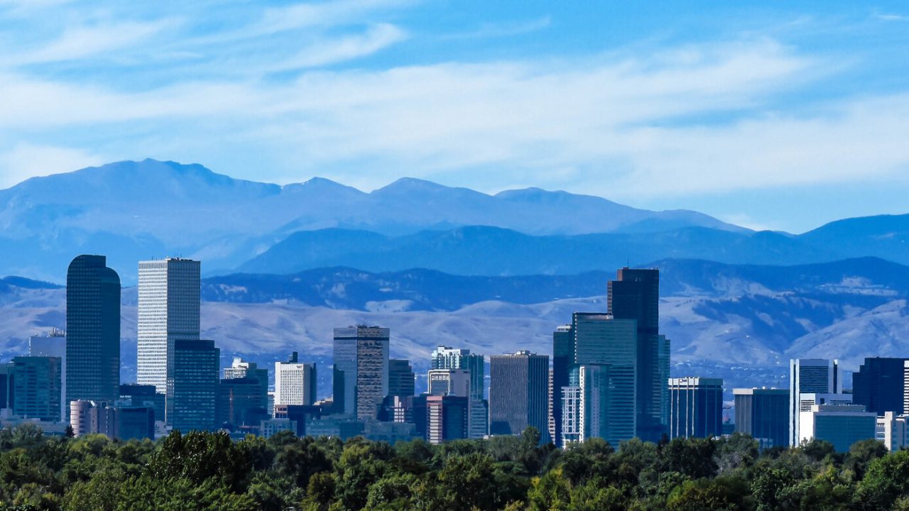 The Denver city skyline, downtown against the backdrop of the Rocky Mountains.