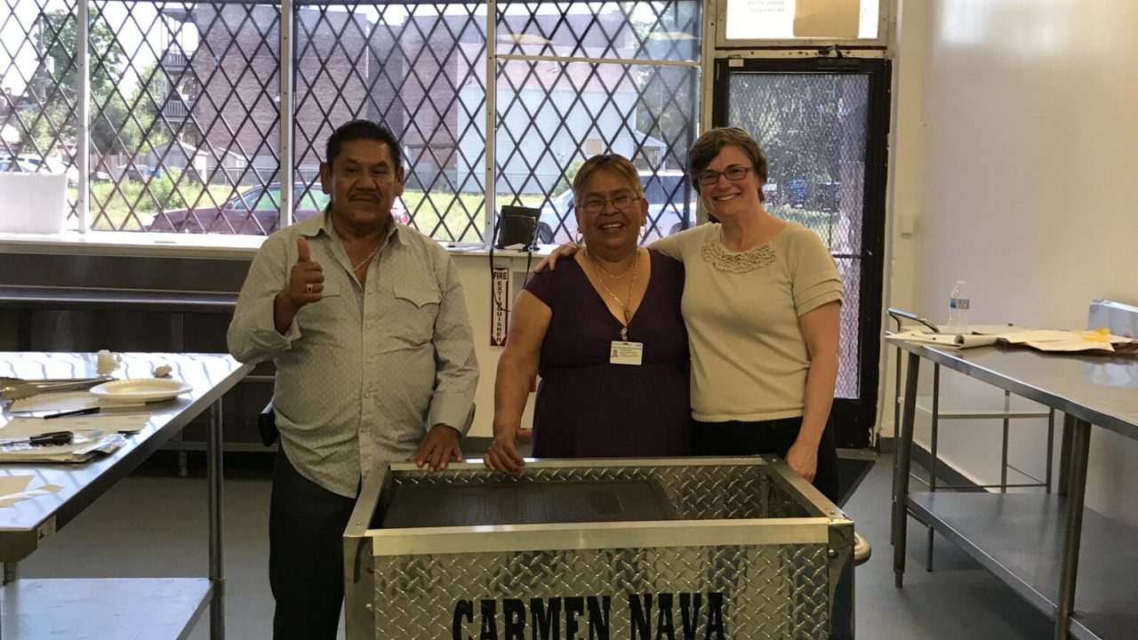 Carmen Nava-Najera, her husband, and IJ Clinic Director Beth Kregor with Mrs. Nava's licensed cart.
