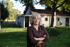 linda camerson standing in front of her home