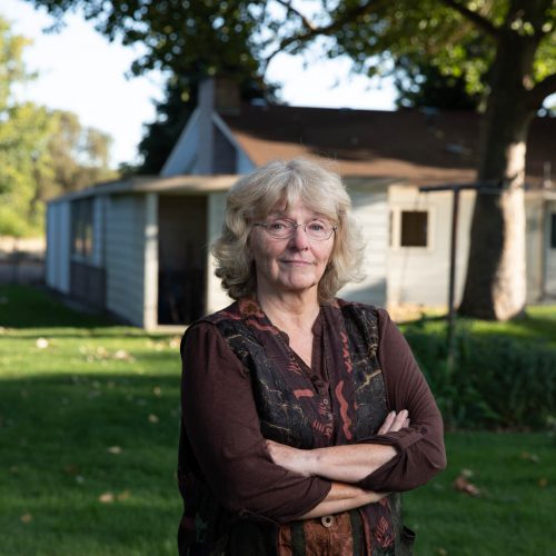 linda camerson standing in front of her home