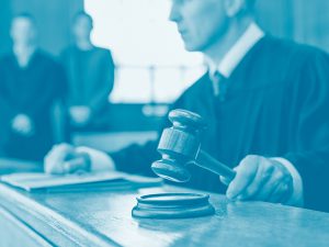 Judge holding gavel in courtroom
