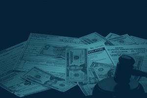 Money, Fees, Citations, and Gavel in a pile on a table