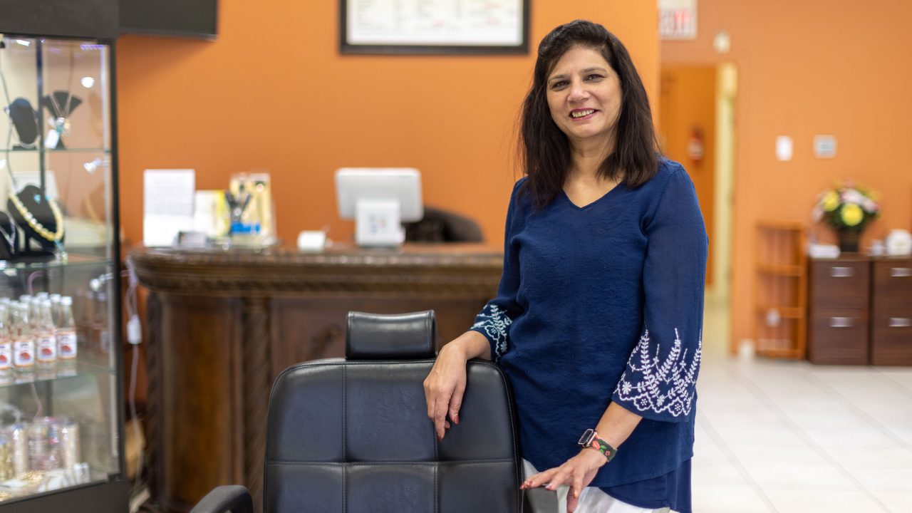 Oklahoma business owner, Seema Panjwani, standing in her eyebrow threading studio.
