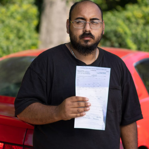 man holding traffic ticket