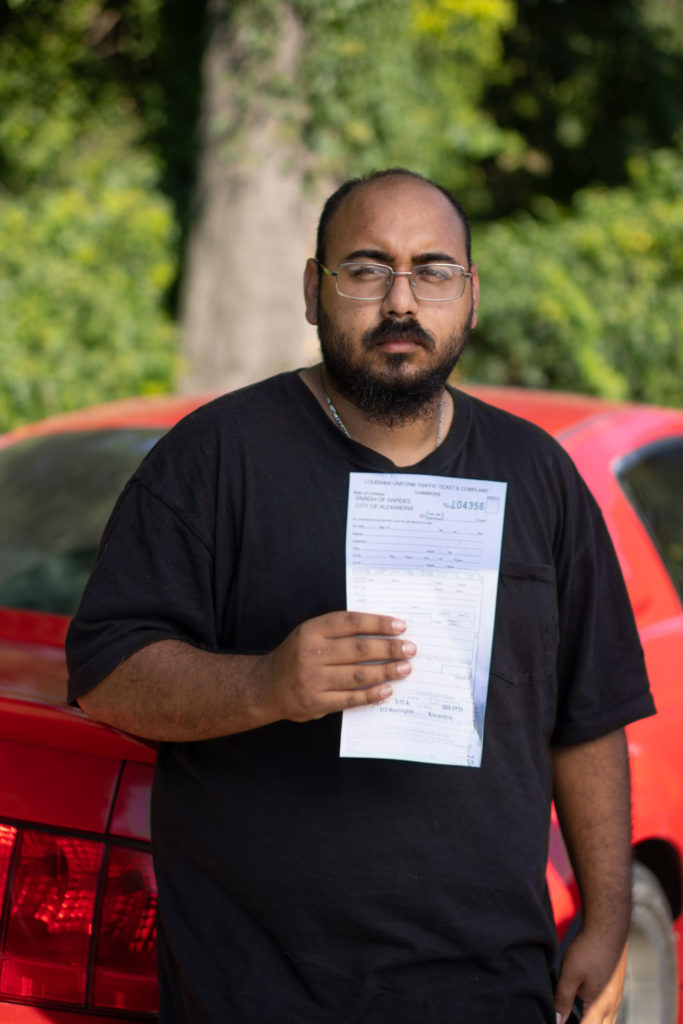 man holding traffic ticket