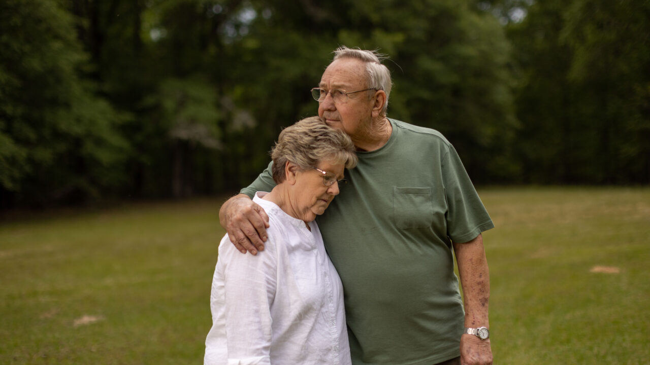 Sally Garrett rests her head on her husband, Don's, shoulder outside their Sparta, Georgia home.