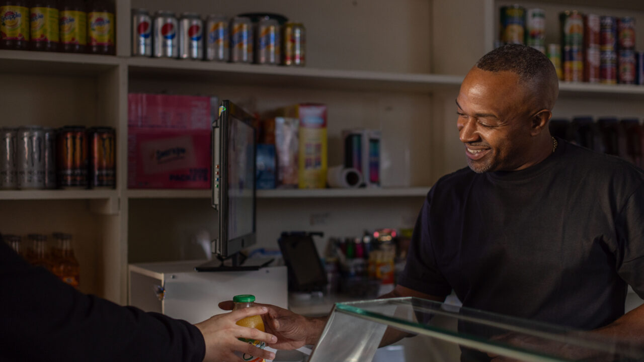 Altimont Mark Wilks cashes out a customer at Carmen's Corner Store, his Hagerstown business. He is suing the USDA over a policy that prevents him from accepting SNAP benefits because of a decades-old arrest, for which he's already served his time.