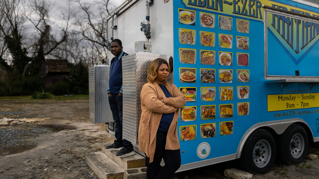 Theslet Benoir (left) and Clemene Bastien stand outside their food truck, Eben-Ezer Haitian Food Truck. Theslet and Clemene are suing the town of Parksley for violating numerous constitutional rights.