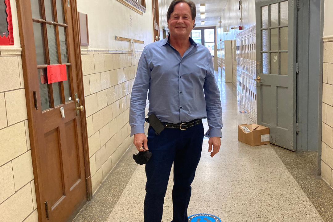 Retired school teacher Will Cramer poses inside school. He has teamed up with the Institute for Justice to file a lawsuit challenging Nazareth, Pennsylvania's ban on 'for sale' signs on cars parked on the street.