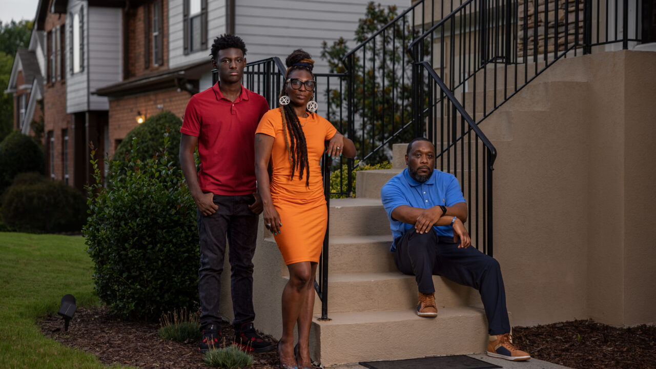 Trina Martin, her son Gabe, and her former partner Toi Cliatt in front of the home the FBI accidentally raided.