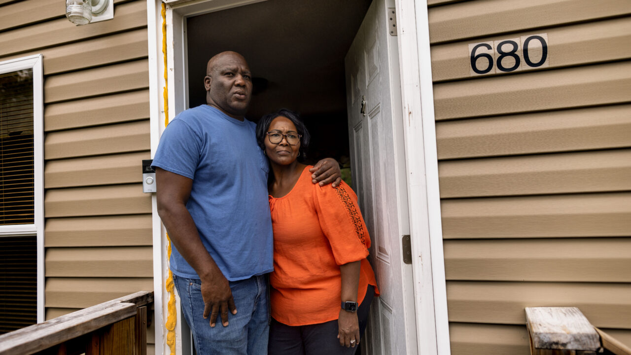 Avery Marshall and Alisa Carr stand in the doorway of their home in Willard, NC. In April 2024, a SWAT team raided their home in a wrong-house raid.