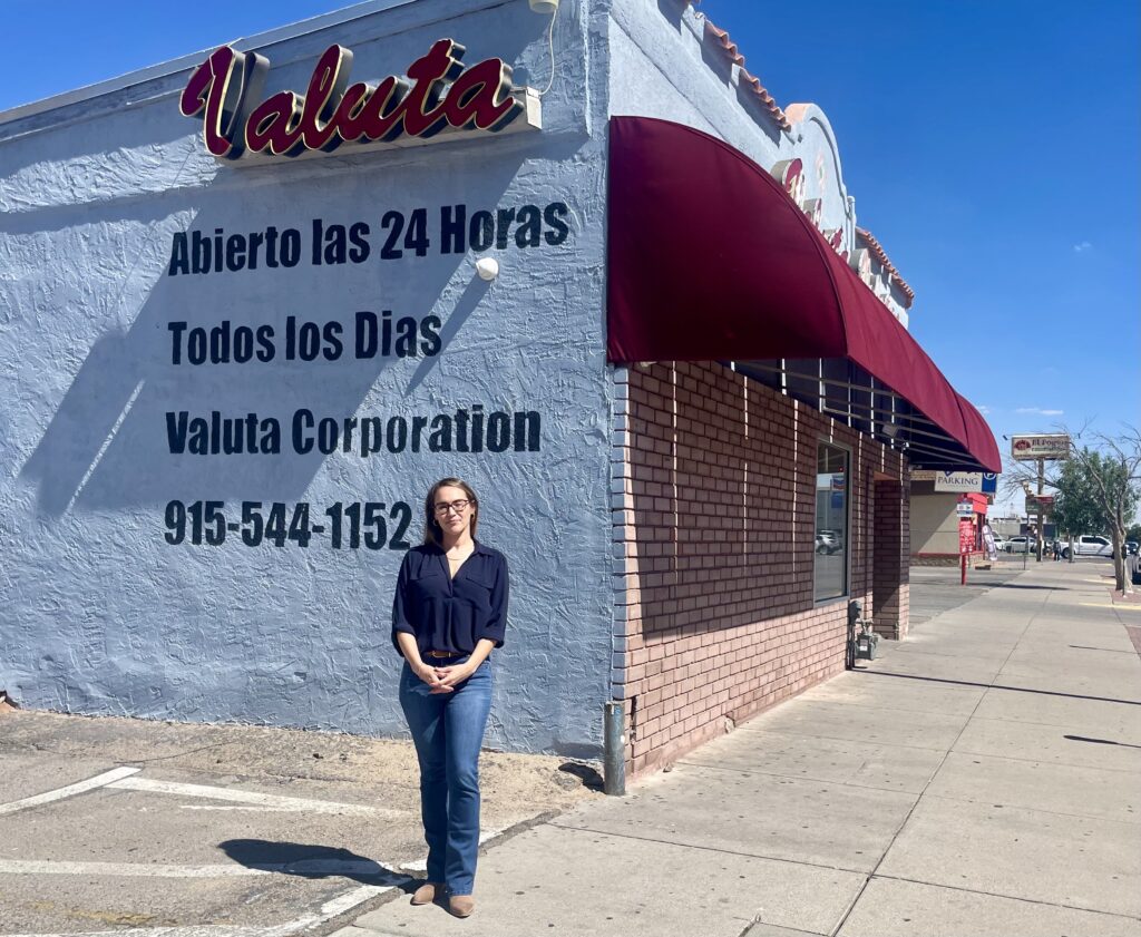 woman stands in front of business