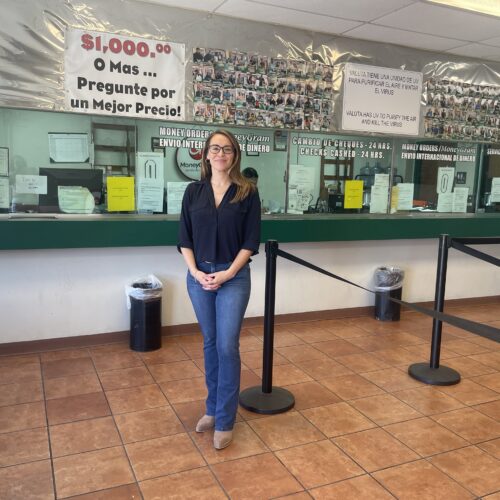 woman stands in front of counter