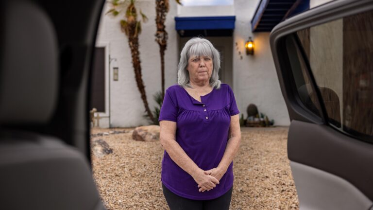 woman standing in front of home and see through car doors