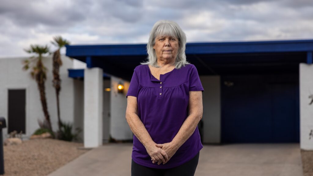 woman standing in front of home