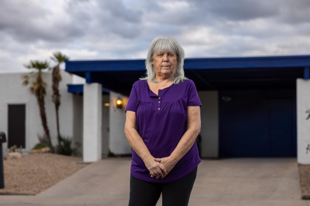 woman standing in front of home