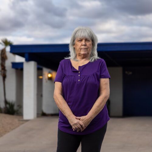woman standing in front of home