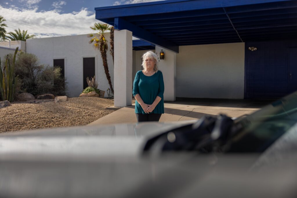 woman standing in front of home