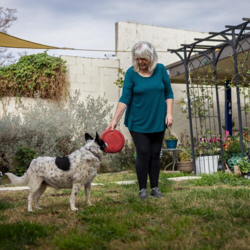 woman with white and black spotted dog