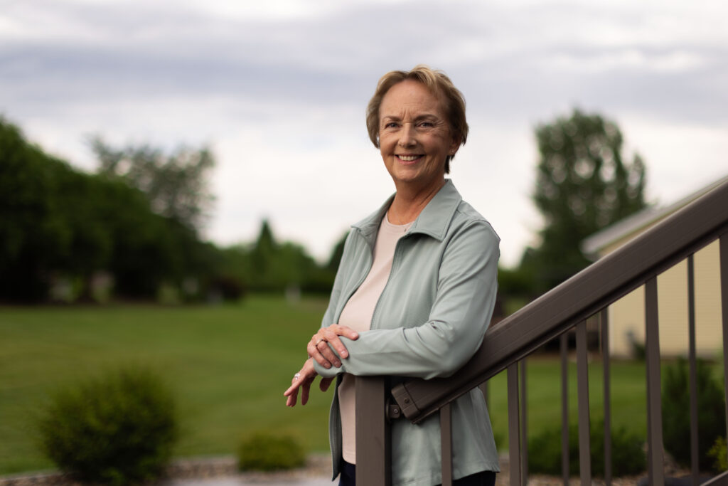 woman standing in her backyard
