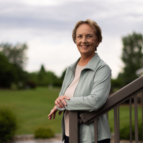 woman standing in her backyard