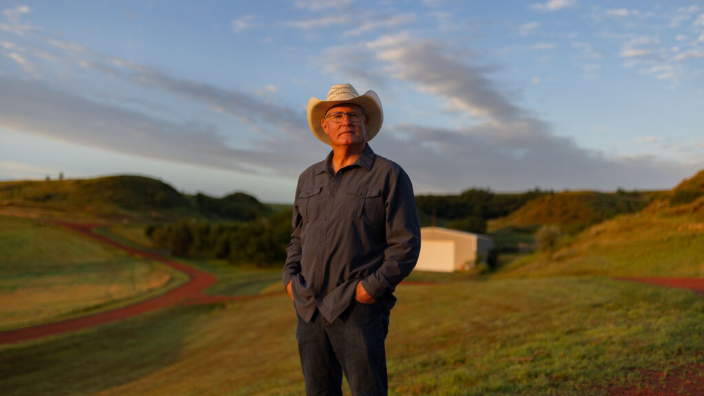 rancher wearing cowboy hat in morning light