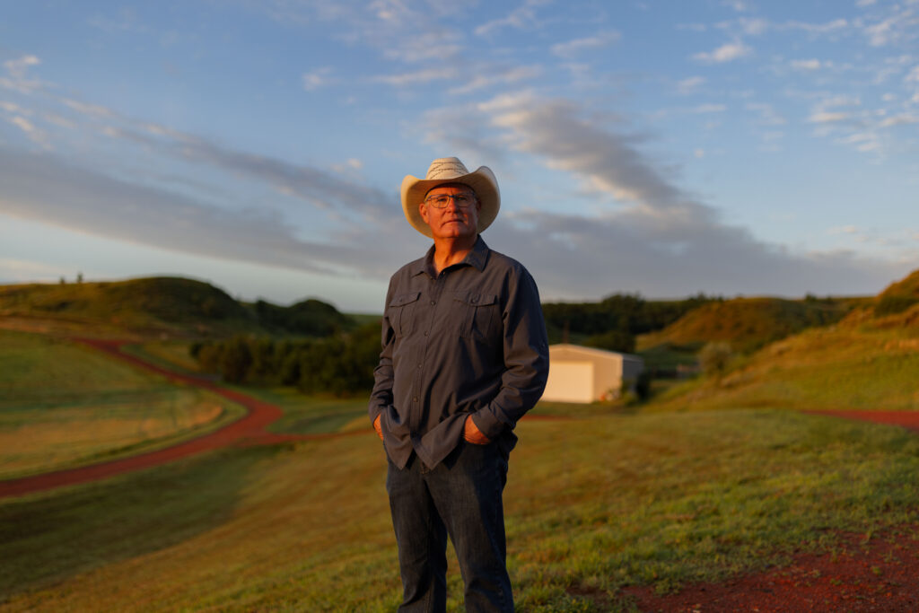 rancher wearing cowboy hat in morning light