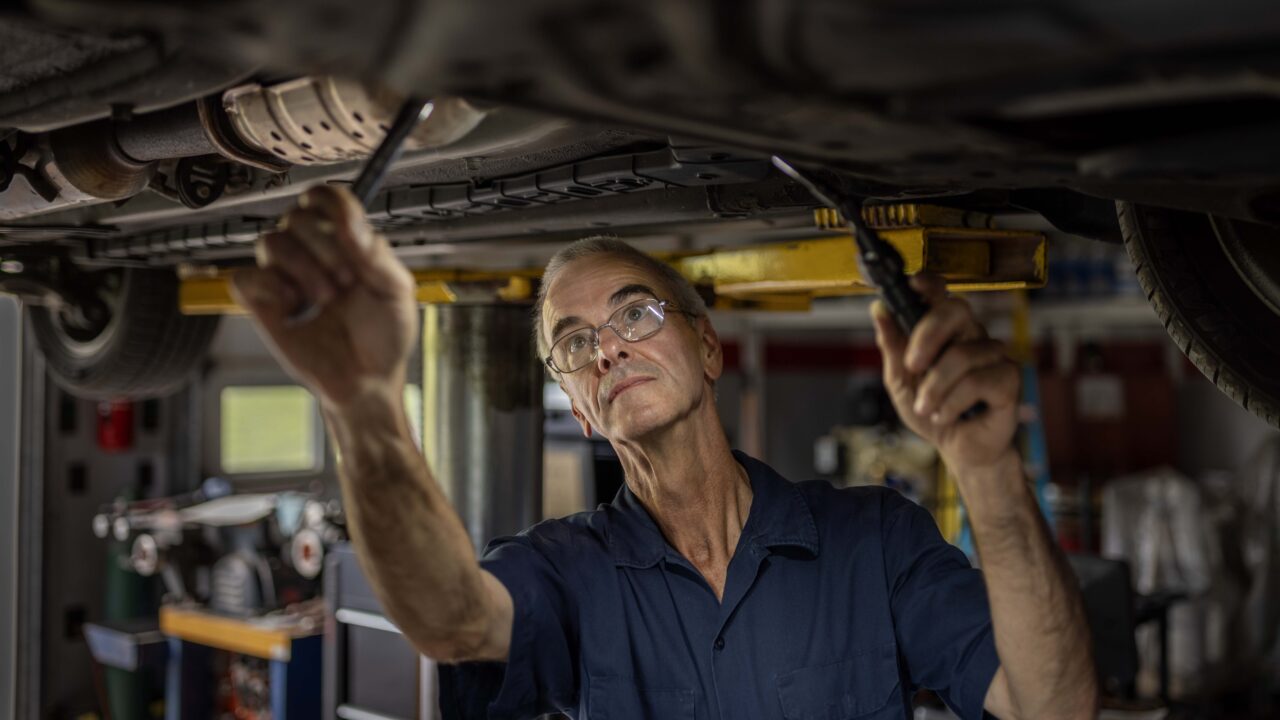 Gene Weierbach works on a car inside his home auto mechanic shop in Slatington, Pennsylvania.