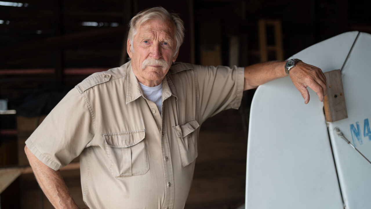 Ken Jouppi leans on his airplane's tail in a hangar, tied to an Alaska forfeiture case