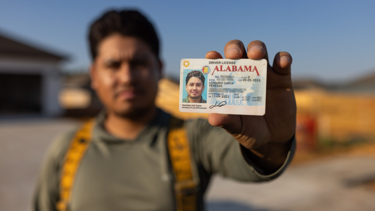 construction worker holding driver's license