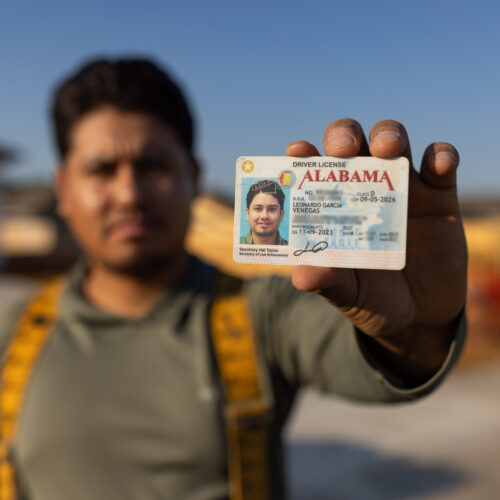 construction worker holding driver's license