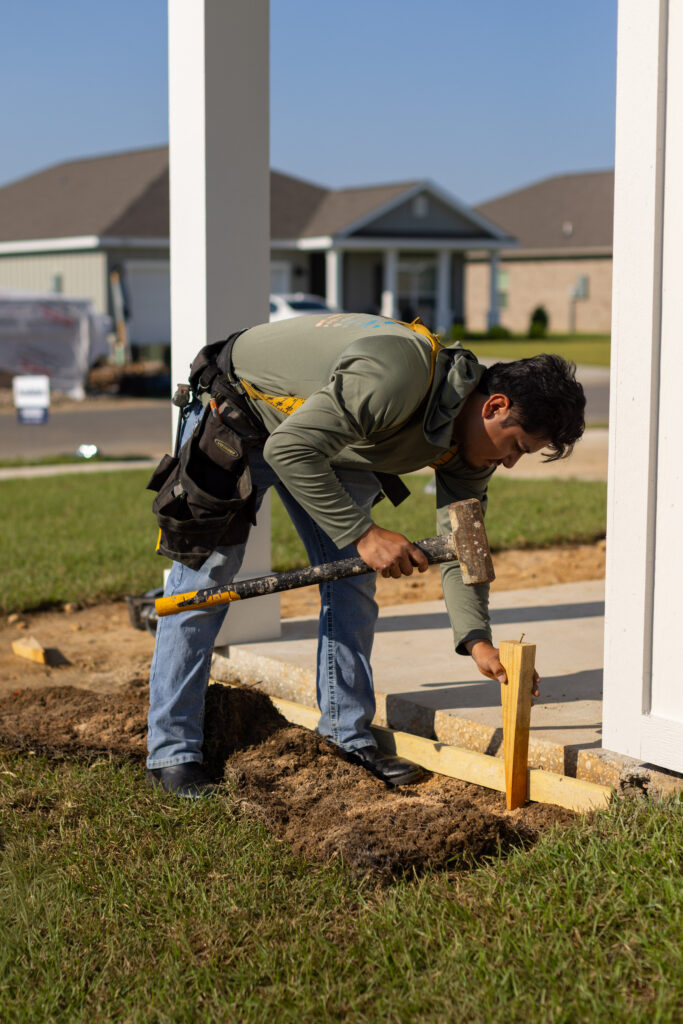 construction worker using sledgehammer