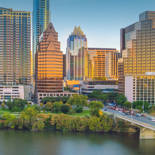 Austin, Texas skyline with riverfront, bridge, and downtown skyscrapers at sunset