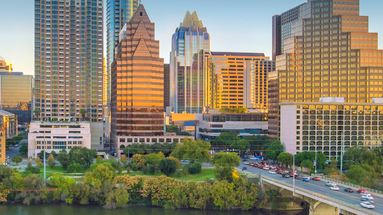 Austin, Texas skyline with riverfront, bridge, and downtown skyscrapers at sunset