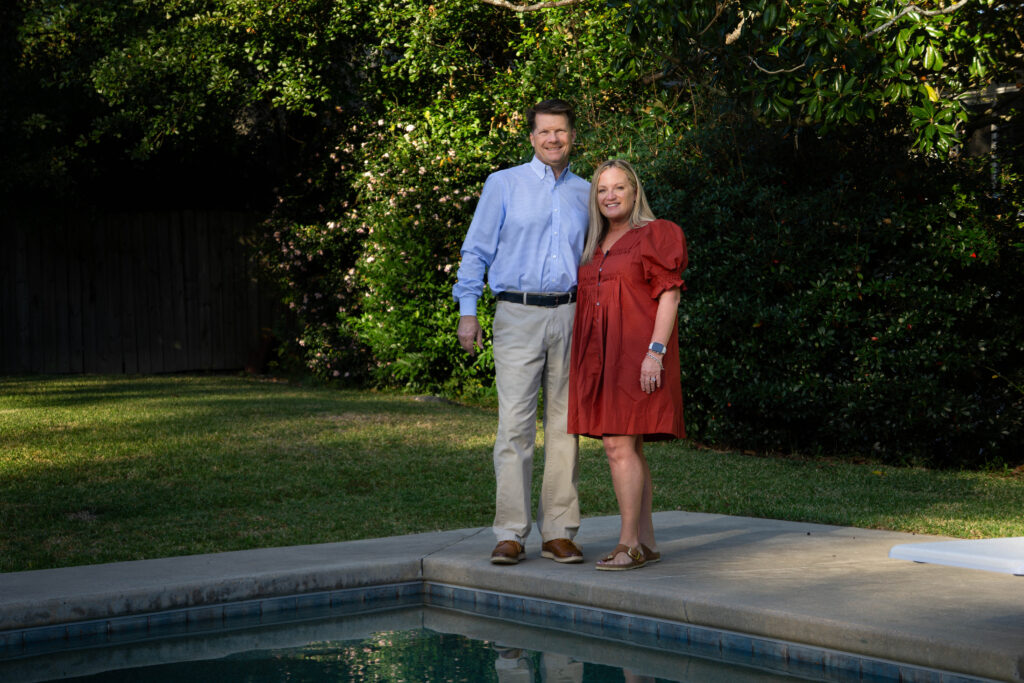 woman and man standing in front of pool