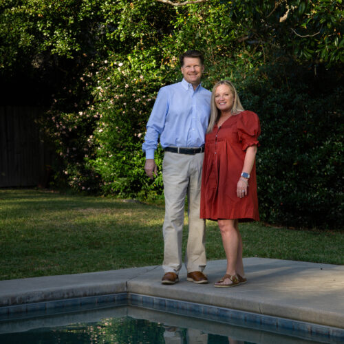 woman and man standing in front of pool