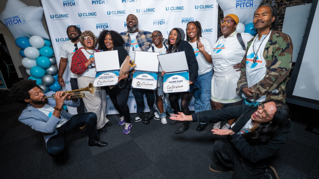Group celebrates with award certificates at South Side Pitch 2025, as Sam Thousand plays trumpet