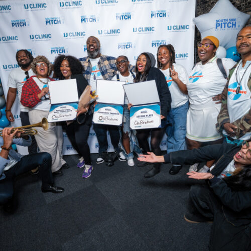 Group celebrates with award certificates at South Side Pitch 2025, as Sam Thousand plays trumpet