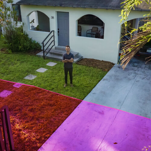A man standing outside his house with a graphic showing the property the city wants to take.
