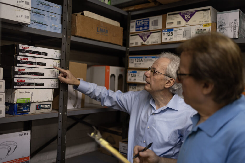 Pashko and Tony Lulgjuraj going through inventory at their apartment building.