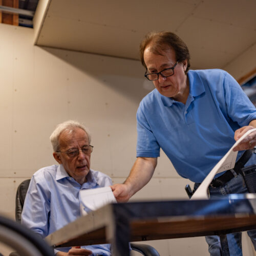Pashko and Tony Lulgjuraj going over the plans of their apartment building.