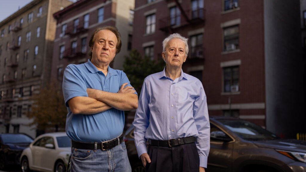 Pashko and Tony Lulgjuraj standing on the street outside their apartment building.
