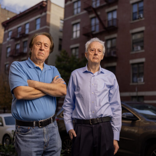 Pashko and Tony Lulgjuraj standing on the street outside their apartment building.