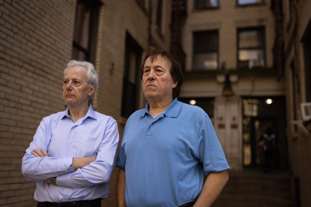 Pashko and Tony Lulgjuraj standing outside their apartment building.
