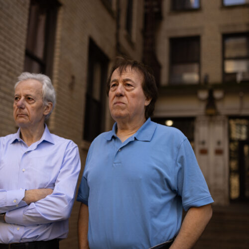 Pashko and Tony Lulgjuraj standing outside their apartment building.