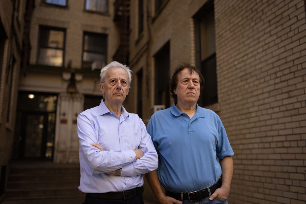 Pashko and Tony Lulgjuraj standing outside their apartment building.