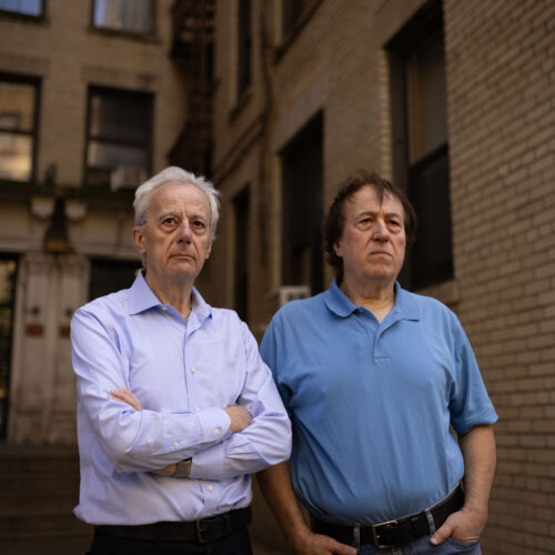 Pashko and Tony Lulgjuraj standing outside their apartment building.