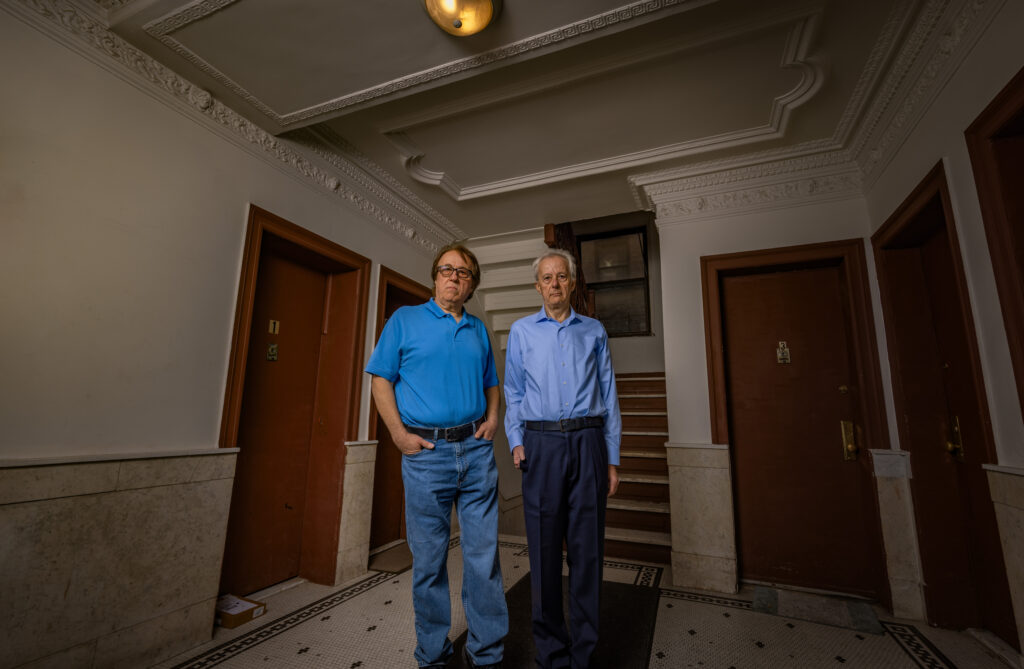 Pashko and Tony Lulgjuraj in the hallway of their apartment building.