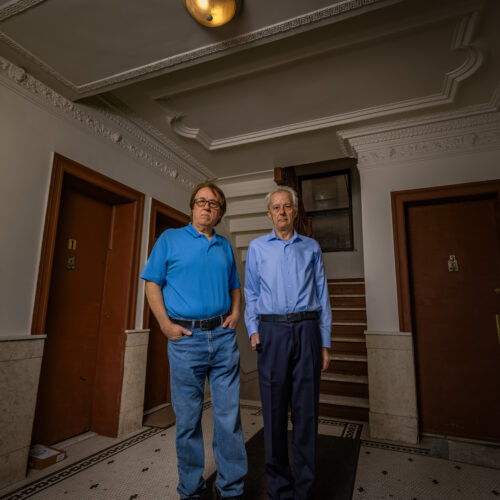 Pashko and Tony Lulgjuraj in the hallway of their apartment building.